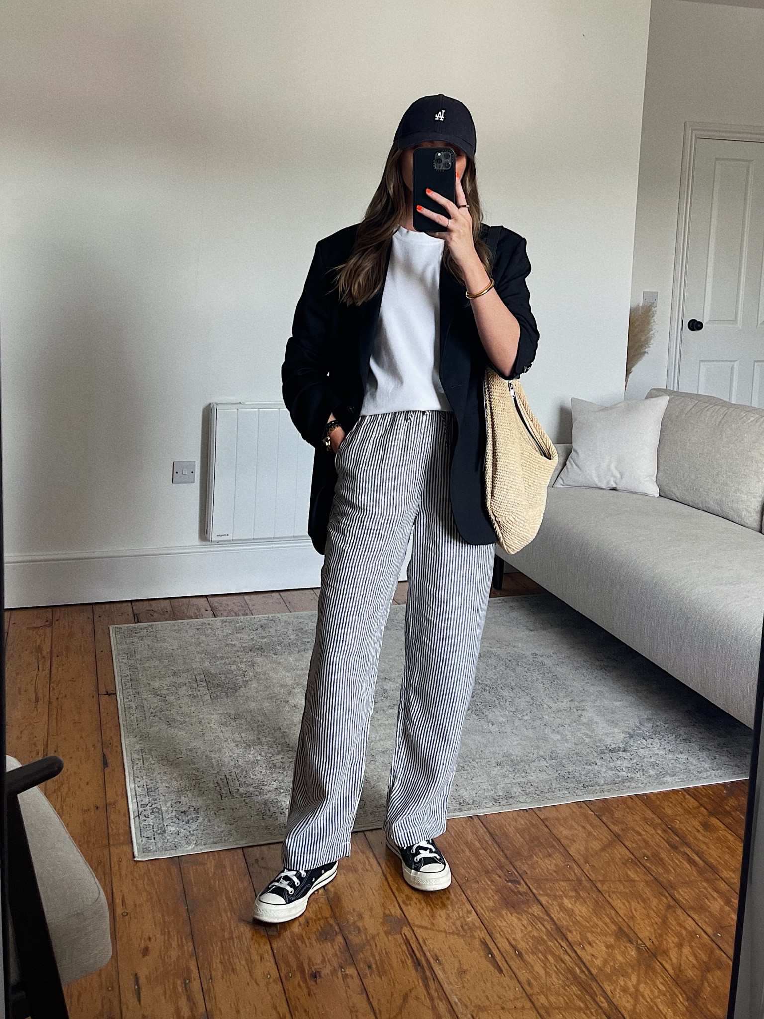 Striped linen trouser styling 
Small in the Arket trousers, I’m 5ft 6
Arket heavy-weight t-shirt
Black H&M oversized black (old) 
Arket raffia slouch bag 
New era cap
Converse chuck 70 hi-tops 
