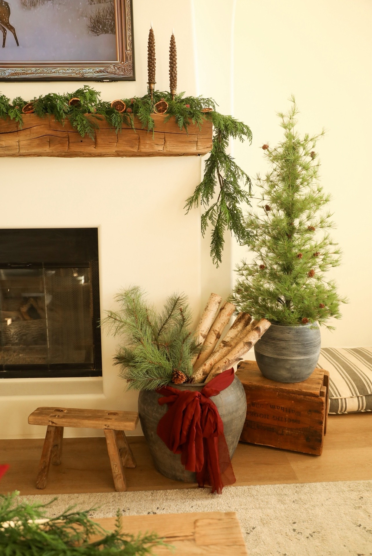 Cozy, rustic holiday styling. They key to getting a high-end rustic look is mixing realistic greenery with vintage items 🤌🏻🎄The burgundy bow is just made out of scrap fabric. #ltkhome #homedecor #christmasdecor #holidaydecor #ltkholiday #rusticchristmas

#LTKHome #LTKHoliday #LTKSeasonal