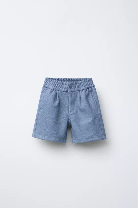 Comfort textured shorts with elastic waistband and front button detail. Front welt pockets and ba... | Zara US