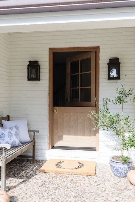 Add major curb appeal to your home with this simple porch decor that is functional as it is beautiful!

Front porch, copper lanterns, Dutch door, welcome mat, blue white planter, blue, white hydrangea, pillow, weather, bench, welcoming, simple, home, decor inspo

#LTKstyletip #LTKSeasonal #LTKhome