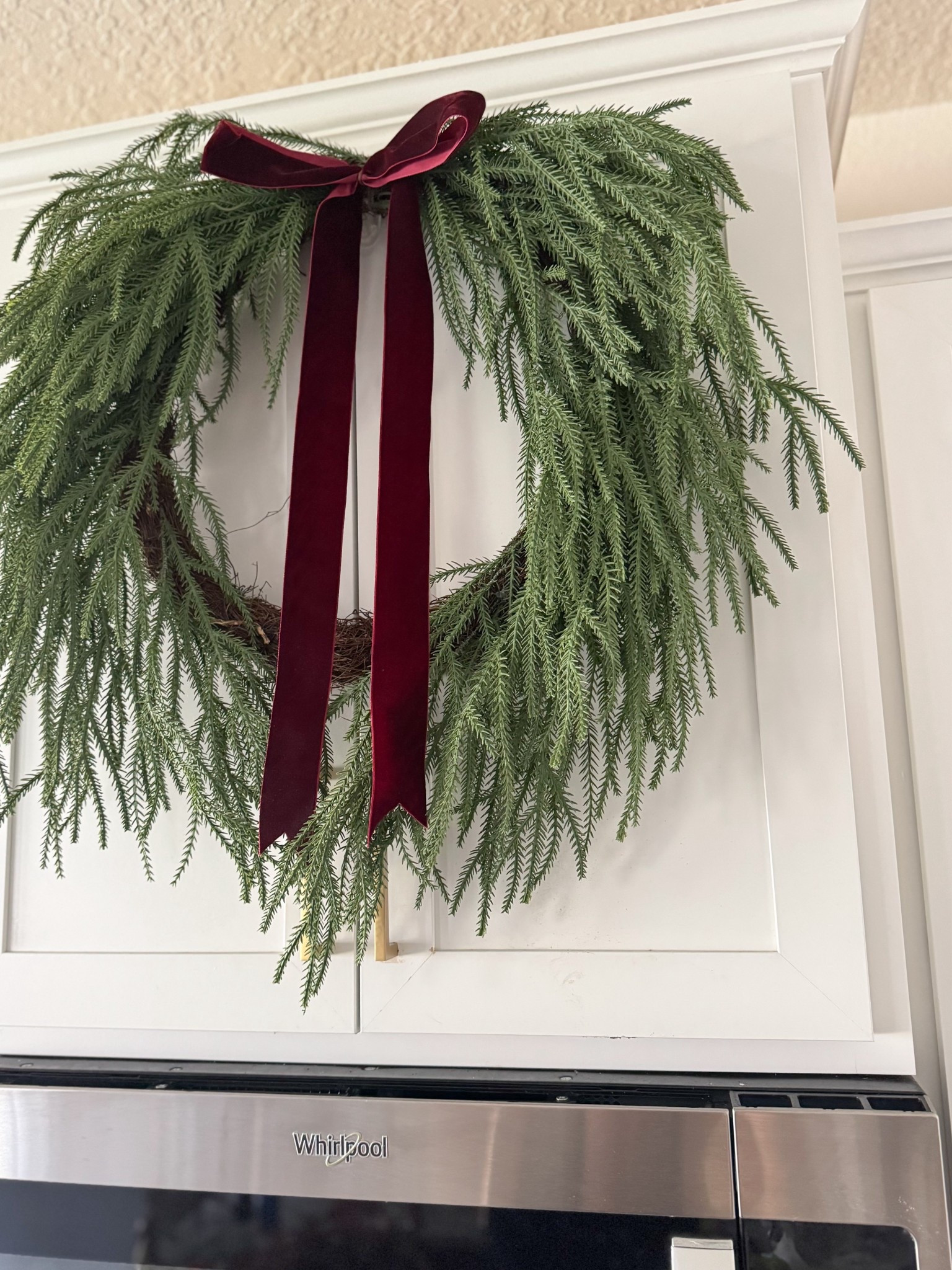 Bring the beauty of the holidays indoors with this 22” Evergreen Norfolk artificial wreath by My Texas House. Lush, natural-feel greenery paired with a rich burgundy ribbon adds instant farmhouse charm to your door, mantel, or wall. Perfect for effortless festive decorating year after year! 🌿🎄 #ChristmasDecor #FarmhouseHoliday #EvergreenWreath #HolidayHome #FestiveFrontDoor #MyTexasHouse

#LTKSeasonal #LTKHoliday