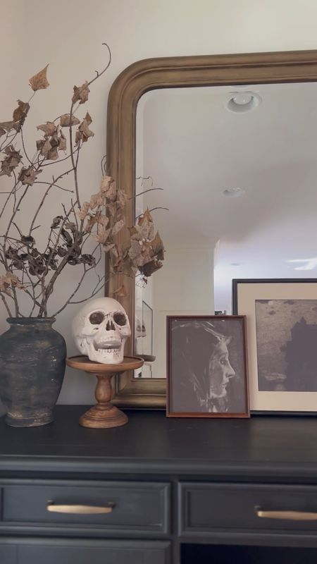Spooky Console Table Styling | Halloween Console Table | Halloween decor | spooky decor | branched  | black vase | found pottery | spooky art | Halloween art | dried florals | fall florals | candle stick holder | bead garland | gold mirror | arch mirror | McGee @ co 

#LTKhome #LTKSeasonal #LTKHalloween