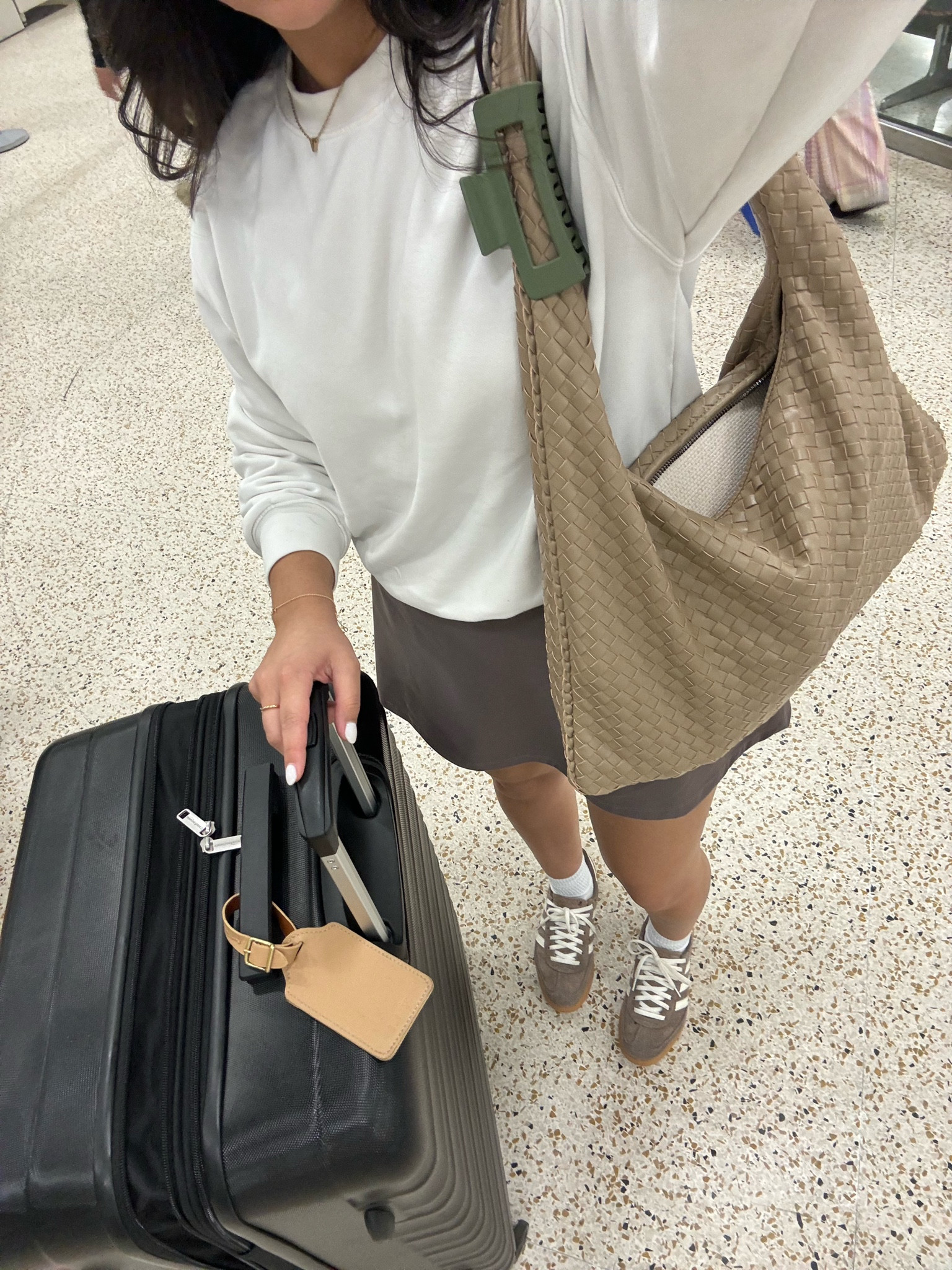 Airport outfit idea 
White sweatshirt: xs 
Brown active dress: small 
Brown adidas handball spezial sneakers: 4.5 men 
White ankle socks 
Woven shoulder tote bag 
Black hard shell luggage 

#LTKTravel #LTKStyleTip #LTKNYFW