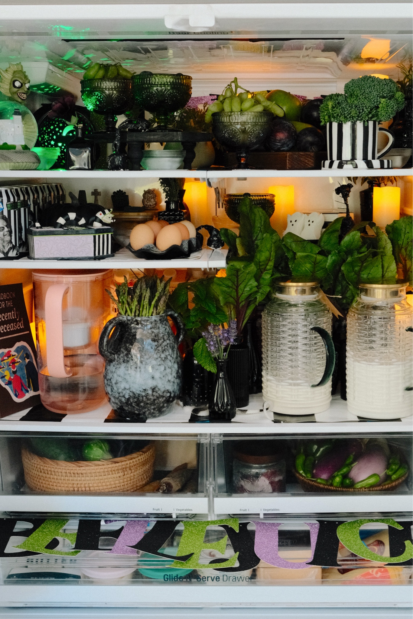 Goodies inside the Beetlejuice fridgescape! 

Refrigerator decor, fridge decor, fridgescape decor, Beetlejuice decor, Halloween decor 2024, Halloween decorations 2024, Beetlejuice snow globe, glass pedestal bowl, purple pedestal bowl, lime green pedestal bowl, coffin serving tray, black
and white striped mug, black Bud vases, Beetlejuice container, black
egg tray, glass pitchers with lids, pitcher with lid, rustic black vase, Beetlejuice sign, Amazon Halloween, Amazon finds 

#LTKHalloween #LTKHome #LTKFindsUnder50