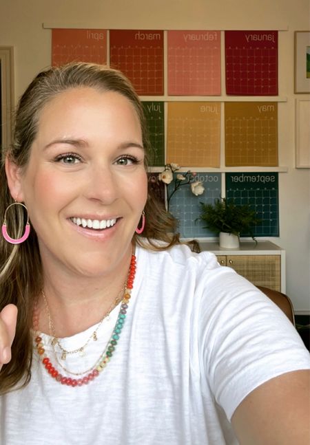 When your new jewelry matches your wall calendar perfectly 🙌🏻 This is my favorite white T-shirt ever, true to size. White T-shirts are the perfect backdrop for colorful jewelry like this. ❤️ rainbow, necklace, colorful necklace, pink earrings, white T-shirt, layering necklace. 

#LTKunder50 #LTKstyletip #LTKFind