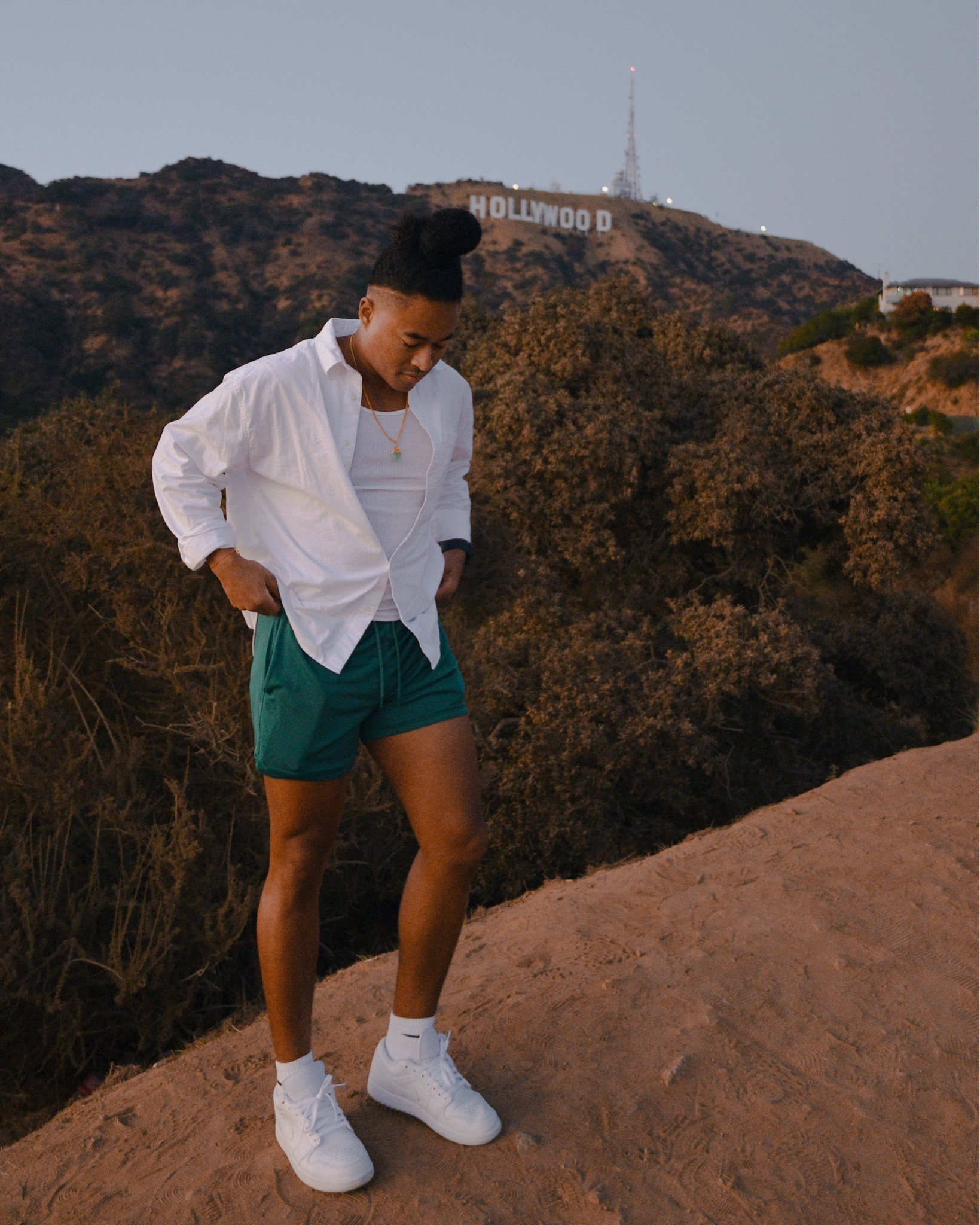 Casual Men's Outfit
- green mesh shorts 
- oversized white oxford button down
- white tank top
- crew cut socks 
- white sneakers 