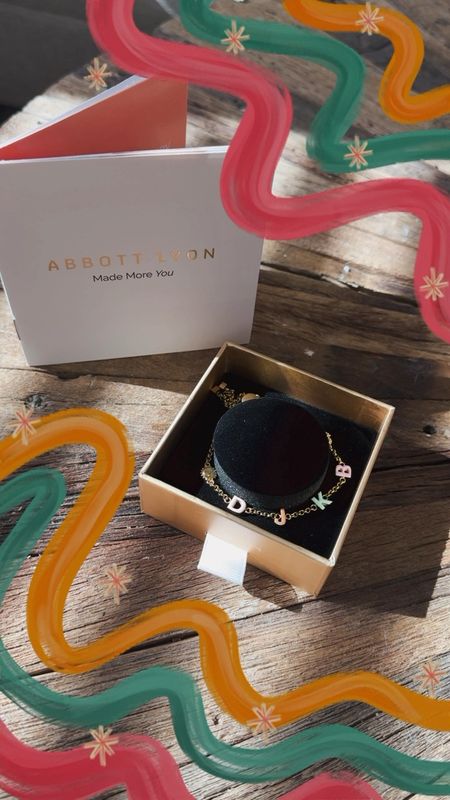 This month’s Abbott Lyon piece 🌈✨ the custom enamel name bracelet with each of my boy’s first initials + a gold sun and baby feet. So cute! #abbottlyon 

#LTKfindsunder100 #LTKGiftGuide