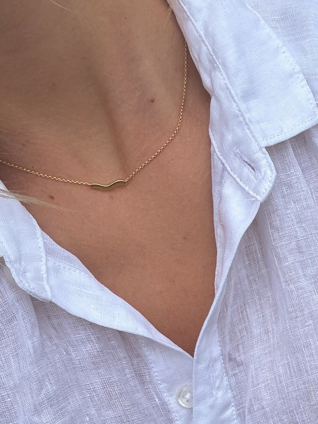Effortless layering. This delicate gold wave necklace adds a touch of minimalist elegance to a classic white linen shirt. #GoldJewelry #MinimalistStyle #LTKunder50 

 #LTKdayinmylife #LTKgrwm #LTKootd