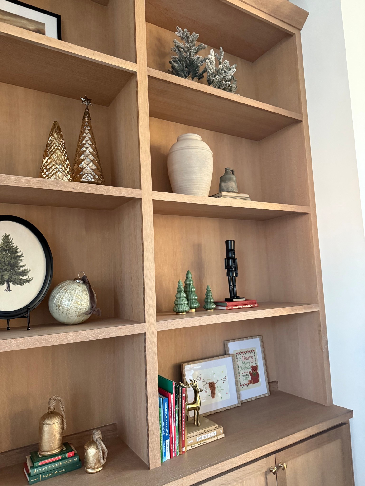 Holiday Christmas book shelf built in decor!Scalloped frame, nutcracker, glass Christmas trees! 

#LTKHome #LTKHoliday