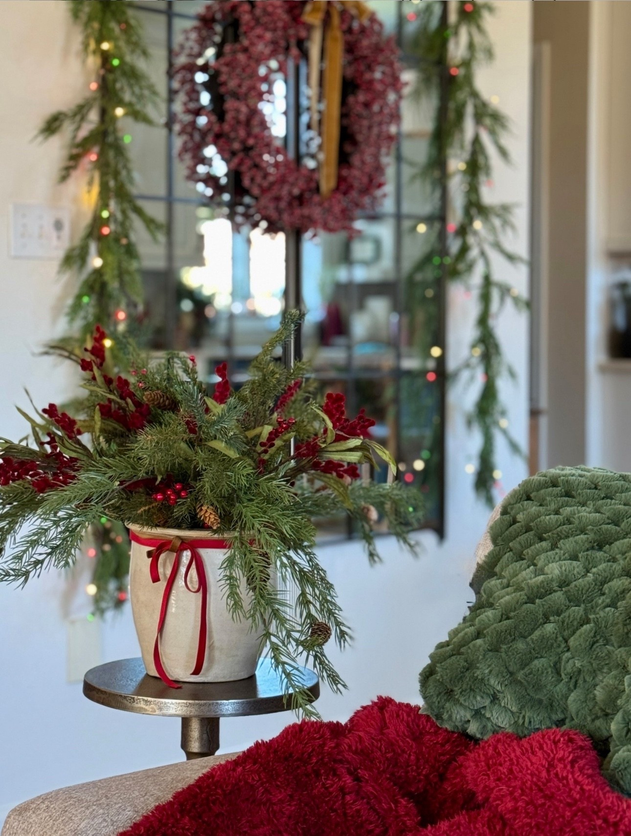 Tall 65x24 rectangular bronze wall mirrors (I have two side by side.) Pretty brushed gold accent pedestal table. Holiday flower arrangement with the prettiest red florals and stems. Velvet ribbon, premade bows and berry wreath. Real touch cedar garland. Red pompom Sherpa throw on sale for under $29 from PB-other colors available! Cozy dark green throw. Multi lights red green and clear. Lots of sales going on now!     

#LTKHome #LTKHoliday #LTKSeasonal