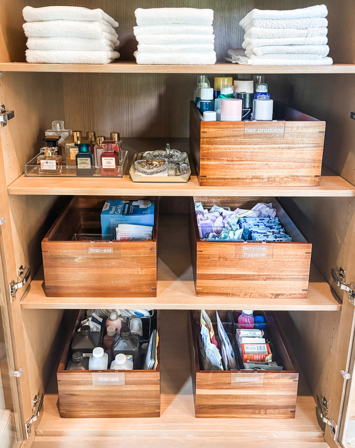 We love a good bathroom cabinet/linen closet. Products and bottles and jars and towels accumulate in the bathroom, but that doesn't mean your cabinets have to look messy! These acacia bins are perfect for corralling 'like' things and keeping the chaos under control which is especially helpful for our clients who find visual clutter really distracting and stressful. 

 
