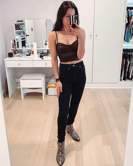 Dark brown faux leather corset style crop top from express. Under $50 great for summer into fall or fall styles. Paired with dark high waisted jeans and snakeskin booties. 

#LTKSeasonal #LTKunder50 #LTKstyletip