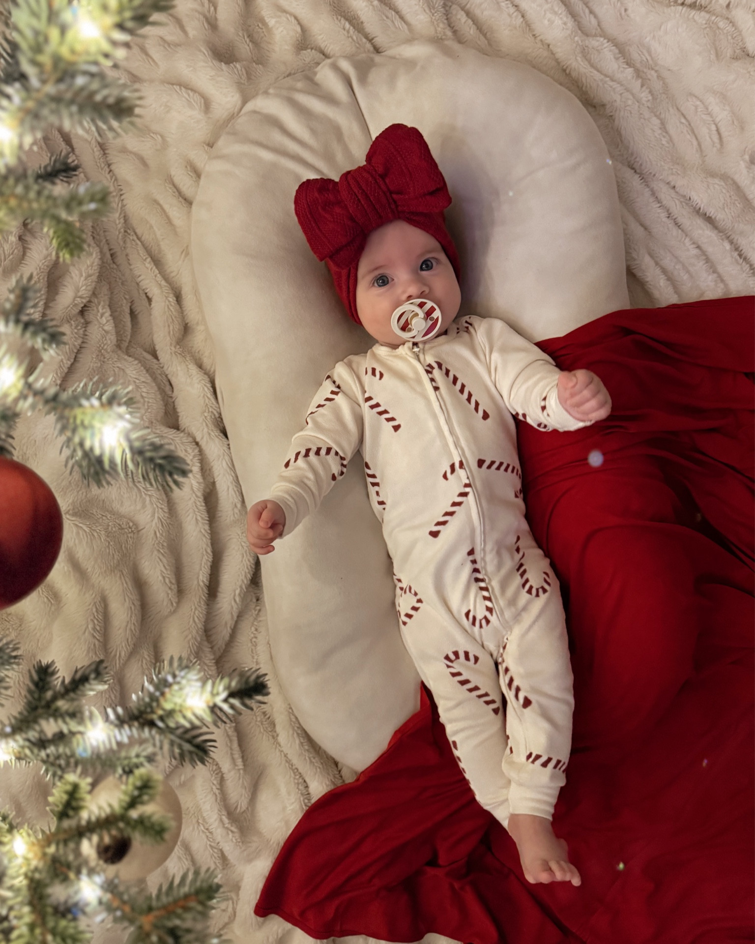 Angel baby ❤️ wearing her Walmart pajamas! Ollie also has this in the toddler one. $12 and so cozy! Linking my red swaddle too (code; FASHIONABLYKAY15) 😍

Solly baby, snuggle me organic, bibs paci, bibs binky, candy canes, babygirl pajamas 

#LTKHoliday #LTKBaby #LTKFamily
