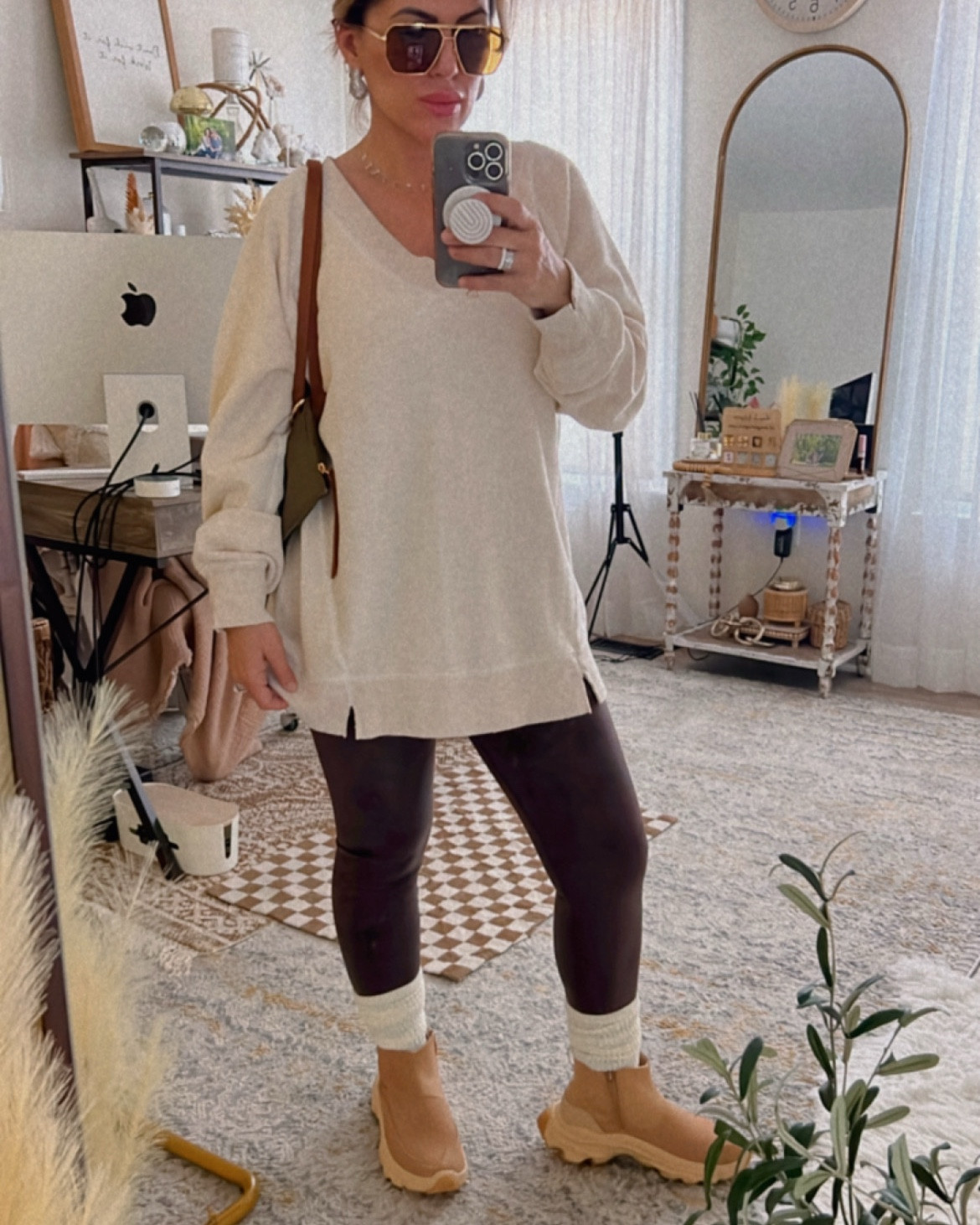 The shirt runs about 1-2 sizes oversized. Wearing an XS in the sweatshirt. Leggings true to size, size small. The bag is the real star here! Looks like LongChamp for a fraction of the cost!