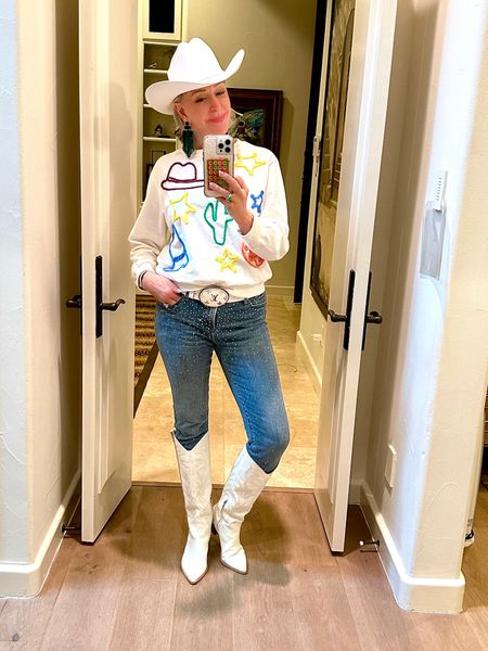 Southwest style  Get your cowgirl boots, sparkle rhinestone studded skinny jeans, add in some crystal fringe earrings and don’t forget get your cowboy hat. For a top wear a cute graphic sweatshirt. 

#LTKstyletip #LTKshoecrush #LTKover40