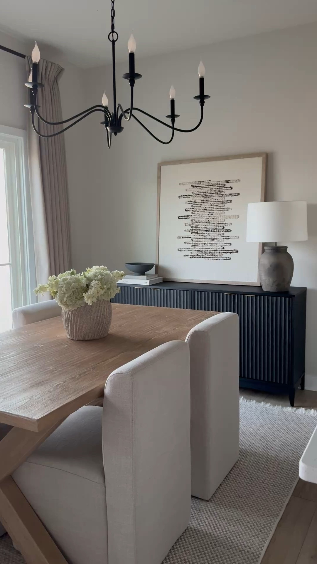 Black sideboard, abstract art, leaning art, amber lewis Getty, art, framed art, fluted sideboard, toscana table, dining room table, dining room chairs, upholstered chairs, amber Lewis rug, Malibu rug, concrete vase, hydrangea stems, lilac stems, arhaus vase, Thornton lamp, black chandelier, linen curtain

#LTKSaleAlert #LTKHome #LTKstorytime
