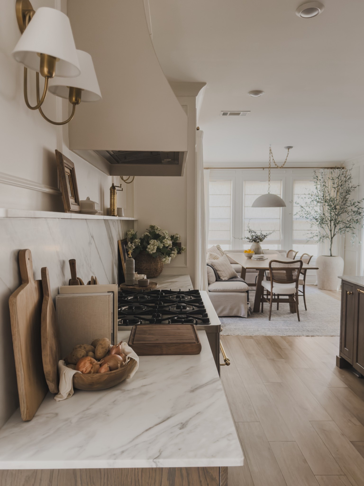 Open concept kitchen views leading into my breakfast nook. When leaving into a lived in, collected style — it meant incorporating cozy seating details to gather around, functional and aesthetic items on display, and making use of every corner and detail.

Home finds, neutral home inspo, collected style, kitchen views, breakfast nook, lighting detail, neutral wood tones, furniture favorites, brass accents, swag light, dining table, banquette, kitchen counter styling, faux floral, brass wall sconce, appliance detial, vintage style area rug, rich wood tones, Pottery Barn style, Four Hands, Amber Lewis, Loloi, McGee and Co, ILVE, Visual Comfort, shop the look!

#LTKSeasonal #LTKHome