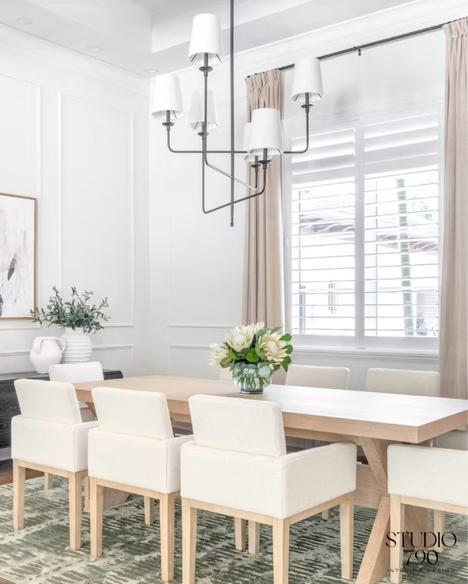 A dining room designed around quiet contrast. Soft upholstery, grounded greens, and sculptural lighting come together for a refined look. 

 #LTKHome