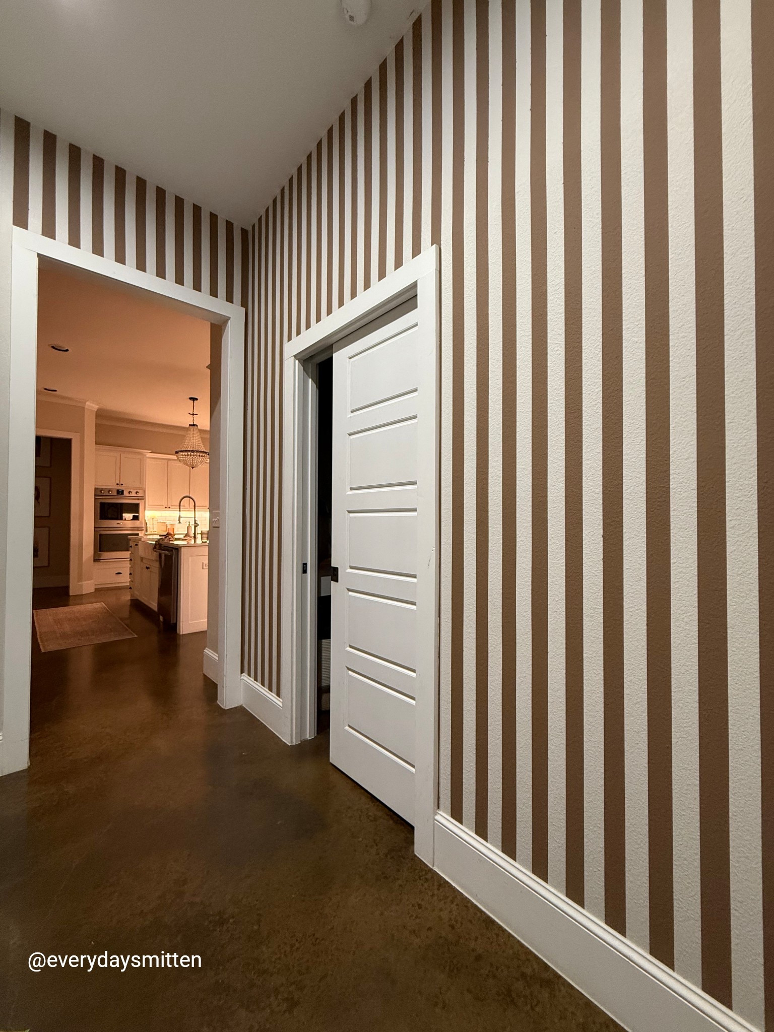 Stripe wall in our mudroom! I can’t get over how much it transformed this room! 
-All Sherwin Williams colors in flat: 
Nuthatch (is the brown shade on wall) 
Basalt Powder (alternating stripe color on wall) 
Pure White (baseboards, trim, ceiling) 

#LTKWatchNow #LTKFamily #LTKHome