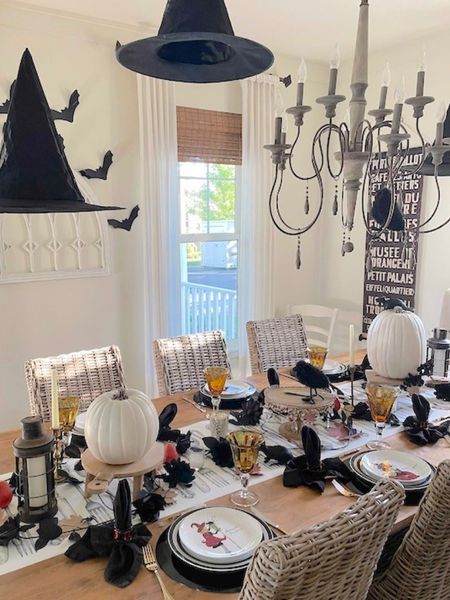 A wicked witchy dinner party! Hang hats from ceiling, tape paper bats to the walls, black faux flowers and candles down the center of table mixed with white pumpkins. Placesettings are white dinner plates on black chargers and witchy salad plates. Sparkling gold goblets and flatware complete the look! #witchytablescspe #witches #flyingwitchhats #halloweendecor 

#LTKHalloween #LTKhome