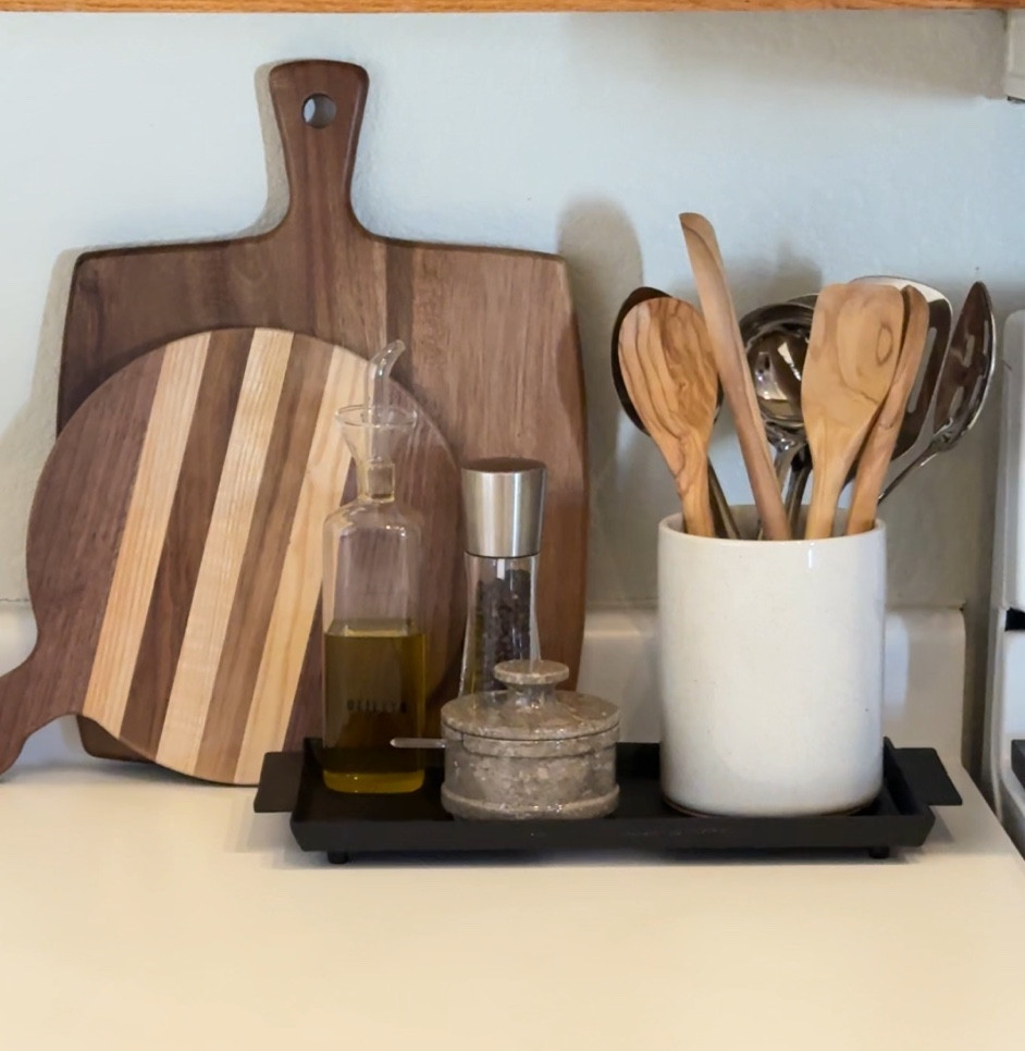 Kitchen counter styling 🤍 

Decided to spruce up our kitchen counter with this cute setup! I love the layered cutting boards with natural stone elements from the salt cellar - oceanic marble! 

••••
Kitchen styling, counter styling, vintage cutting boards, decorative cutting boards, kitchen decor, salt cellar, oil dispenser, olive oil bottle, pepper mill, wooden spoons, wood kitchen spoons, kitchen utensil holder, cast iron tray 


#LTKHome #LTKStyleTip #LTKFindsUnder50