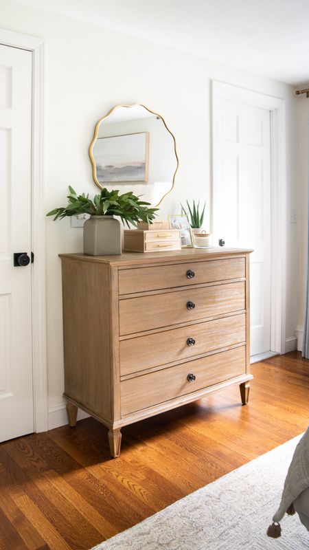 Coastal style bedroom decor and furniture with wood dresser, gold scalloped mirror, artificial plants, and more home decor

#LTKhome #LTKfamily
