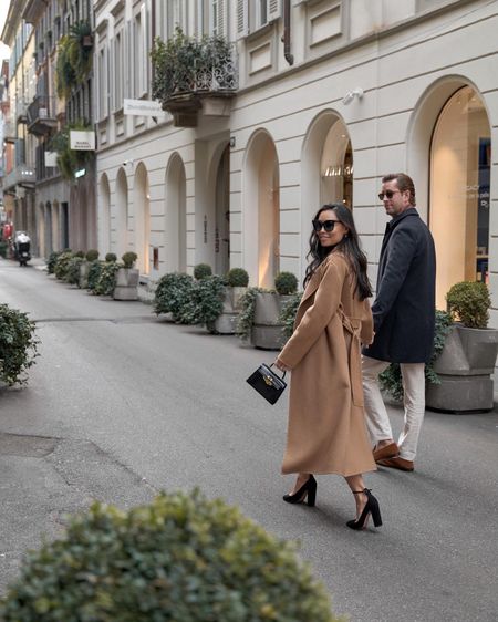 Kat Jamieson wears a camel coat, black heels, leather skirt, black bag and cat eye sunglasses in Milan. Winter style, spring style, fashion week, workwear. 

#LTKtravel #LTKshoecrush #LTKSeasonal