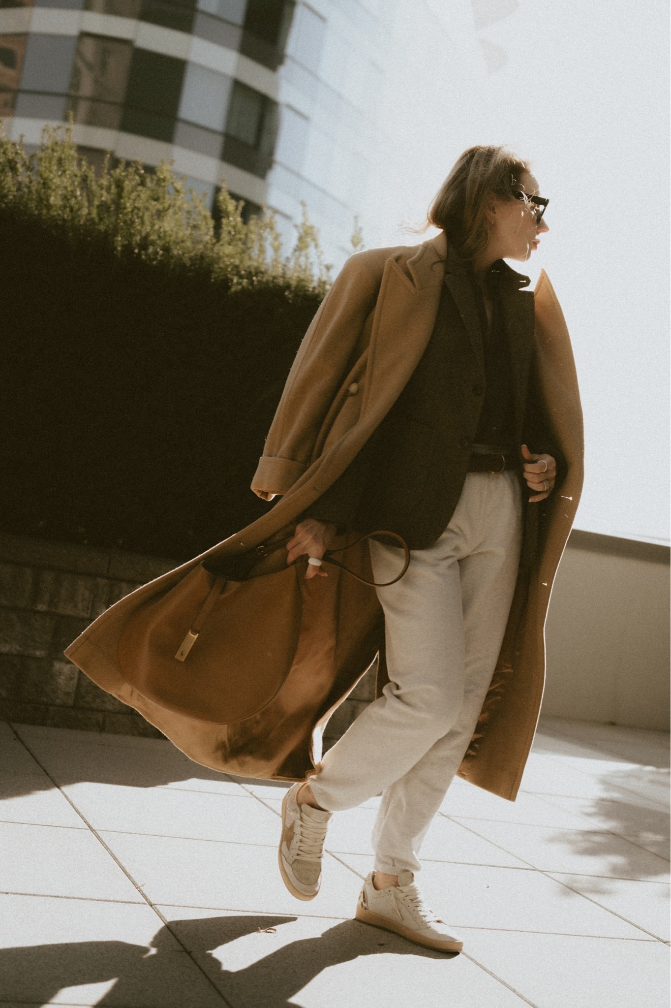 Channeling Ralph Lauren Fall 🍂🍁
Peak lapel camel coat layered over a herringbone blazer, styled over a black cotton shirt & gray sweatpants. Hobo bag  Polo Ralph Lauren Camel-hair Long Polo Coat 
Sweatpants, shirt, herringbone blazer, belt - all Buck Mason 
Bag: Polo Ralph Lauren Polo ID & Golden Goose bball all star sneakers 
Sneakers: Golden Goose ball Star sneakers

Polo Ralph Lauren Camel-Hair Long Polo Coat in camel, worn open and swinging over a Buck Mason Shrunken Academy blazer in dark olive-brown wool, with a Buck Mason Mainstay shirt underneath and Buck Mason sweatpants in cream. Carried by hand: the Polo Ralph Lauren Polo ID  Large Shoulder Bag in tan with a gold-tone plaque. Golden Goose Ball Star sneakers in white leather with a star patch and a distressed, lived-in look. Smart-casual fall styling: camel long polo coat outfits, camel coat with sweatpants, Buck Mason layered looks, Polo ID suede bag styling, Golden Goose Ball Star sneakers, and neutral elevated-athleisure wardrobe ideas for women.