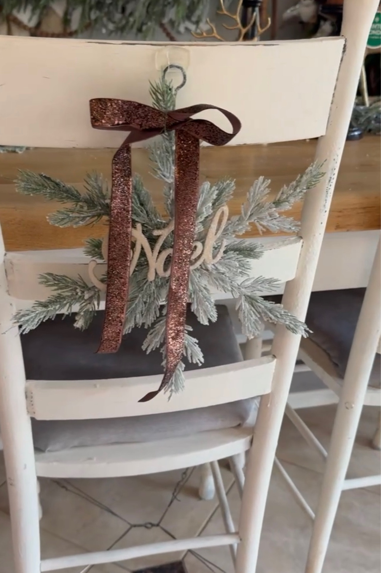 Diy chair decor. We used command hooks and hung these adorable snowflakes. We then added a brown ribbon  

#LTKHoliday #LTKSeasonal #LTKhome