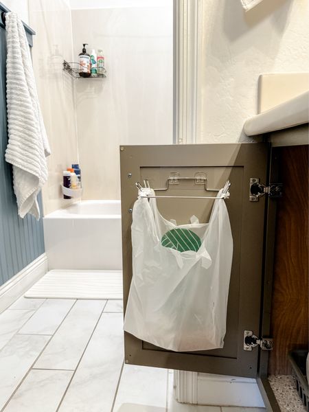 If you have a SMALL bathroom… you NEED this hidden garbage bag hack! This is a simple adhesive garbage bag holder - it takes up zero floor space, and instead utilizes the unused space behind your cabinet doors! It also looks much prettier (because I have yet to find a trash can that looks pretty when it’s full of garbage) 😉 It also just uses grocery store bags, so you’re not having to order anything extra! We have added them to all our bathrooms & love them so much!!

#LTKfindsunder50 #LTKhome