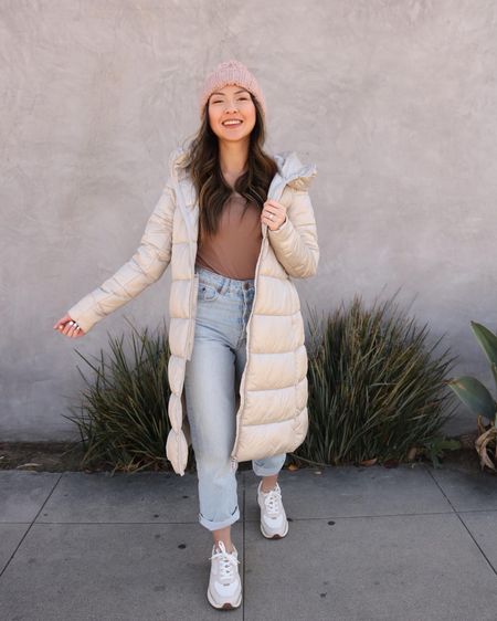 Neutral tones, cozy winter outfit, long beige puffer coat, knit beanie, Madewell sneakers, light wash straight jeans