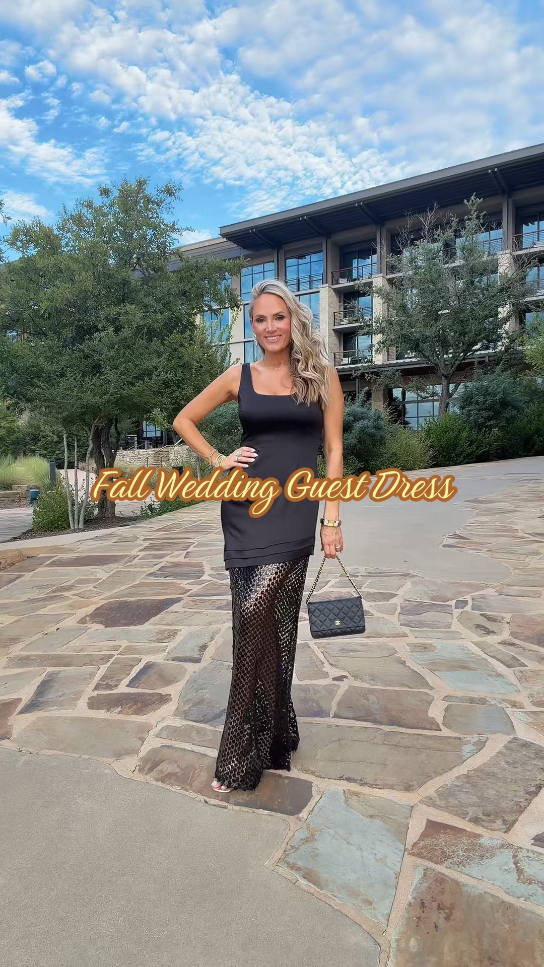 Falling for this one. 🍂✨ This black beauty is giving me all the elegant, sultry vibes with its fitted, sleeveless bodice and flattering square neckline — the perfect canvas to show off a little skin without going overboard. And can we talk about that skirt?! The sheer, mesh overlay with the dreamy circular textured pattern floats all the way to the floor, creating movement and drama with every single step. It's romantic, it's a little edgy, and it's 100% show-stopping.

This is officially my pick for the ultimate fall wedding guest dress — sophisticated enough for an "I do," but with just enough sheer detailing to keep things interesting. Swap the setting to a candlelit holiday party or a NYE affair and it transforms effortlessly into your go-to statement piece. Pair it with a little quilted top-handle bag and some gold accents (like I did here 👀) and you're basically guaranteed to be the best dressed in the room.

Whether you're celebrating love, the holidays, or just a Tuesday that deserves a fabulous outfit — this dress does it all. 🥂🖤 wearing 4

#FallFashion #WeddingGuestDress #HolidayStyle #OOTD #BlackDress               @LTK @Ramy Brook @Saks Fifth Avenue

#LTKNYFW #LTKOver40 #LTKWedding

Comment SHOP below to receive a DM with the link to this post on my LTK ⬇ https://liketk.it/6mrdH

#LTKNYFW #LTKOver40 #LTKWedding