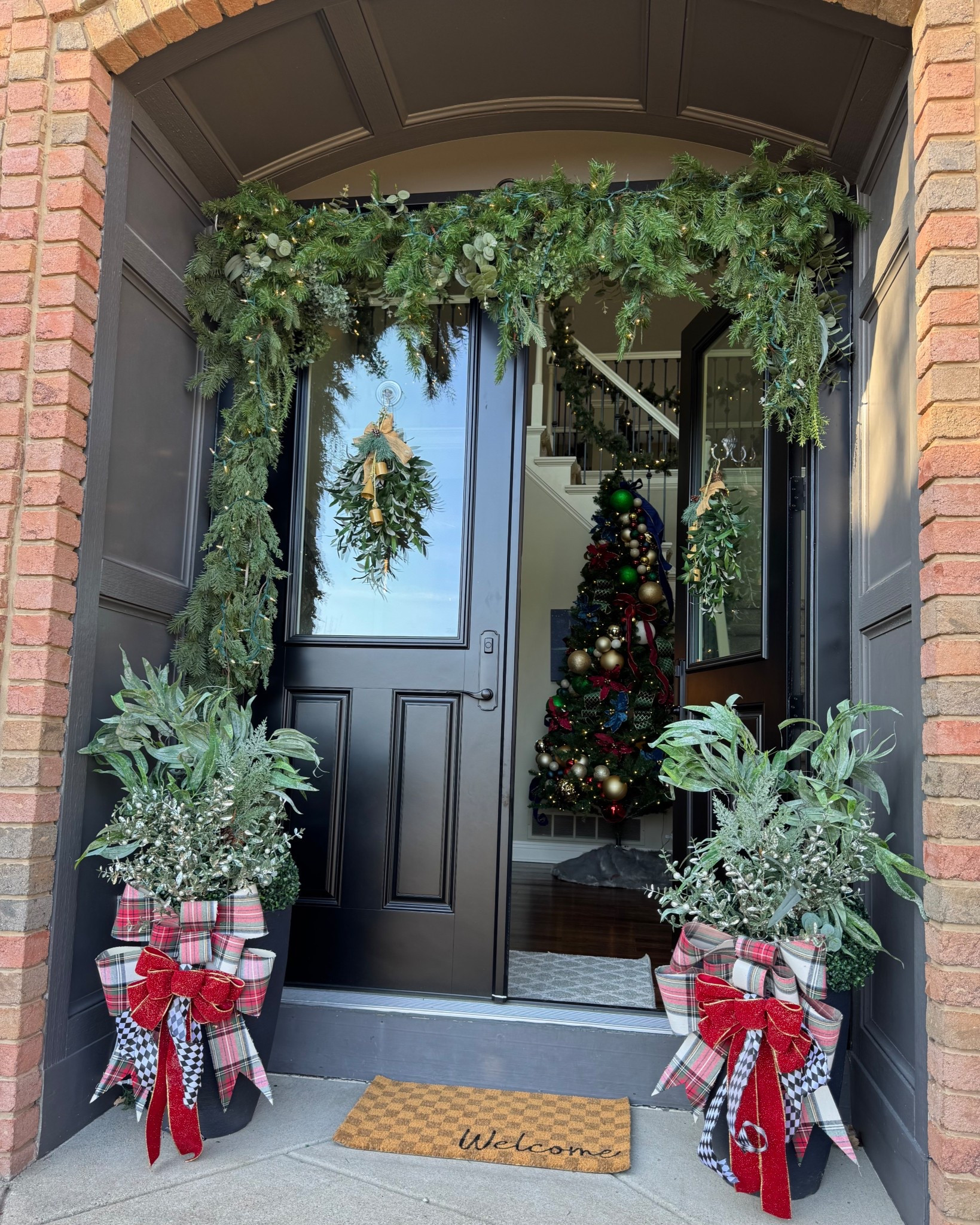 Christmas front porch. Holiday home decor. Christmas decorations. Garland. Front porch decor. Norfolk pine. Black front door. Modern home decor. Classic Christmas decor. 

#LTKCyberWeek #LTKHoliday