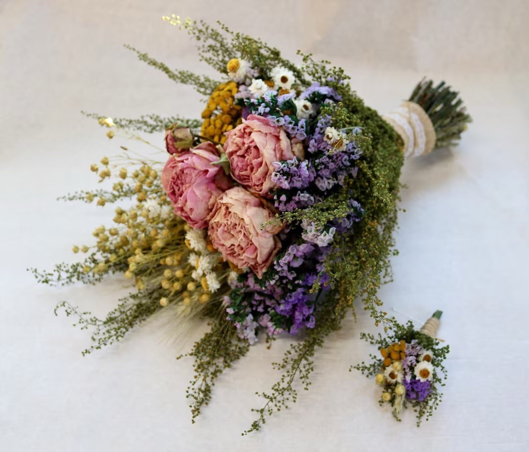 Bring soft country romance to your special day with this Meadow Pastels dried flower bouquet and matching boutonniere. Crafted with preserved blooms, flax, wheat, peonies, and everlasting accents, each piece is finished with burlap ribbon and jute twine for rustic charm. Perfect for weddings, bridal portraits, or keepsake florals that last long after the celebration. #LTKWedding #BridalBouquet #DriedFlowers #RusticWedding #CountryWedding #Boutonniere #WeddingInspo #EtsyFinds #BohoWedding #ForeverFlowers

#LTKSeasonal #LTKWedding #LTKHome