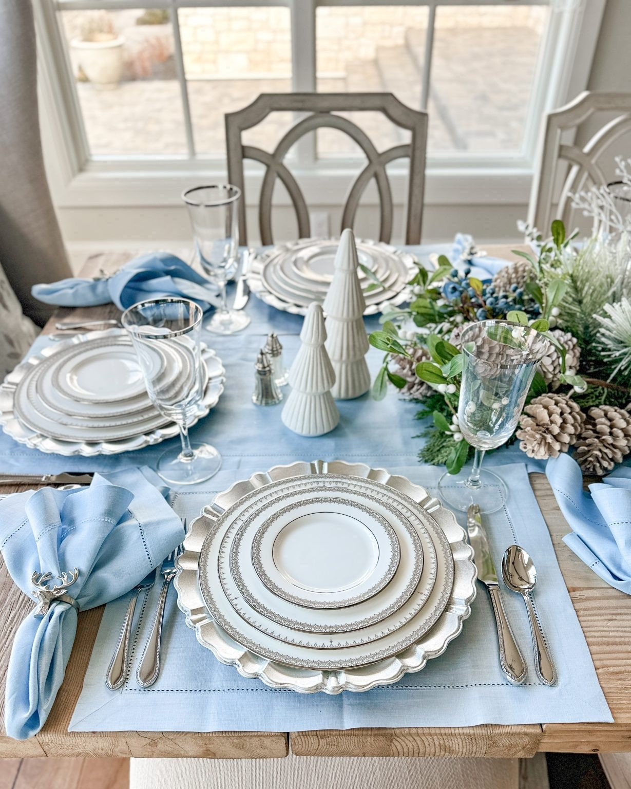 For each place setting, I used my Lenox Lace Couture china, which has a delicate silver pattern around the edges that ties in perfectly with the silver chargers underneath. The light blue linen placemats and matching napkins, from Solino Home’s Classic Hemstitch Collection, add warmth and softness. Consequently, the look remains cohesive.

#LTKHome #LTKHoliday