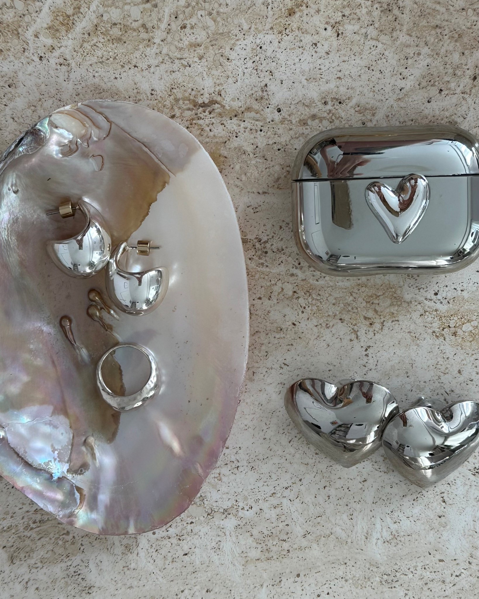 Silver linings only… dome ring, heart earrings, drop earrings and even a heart AirPods case. Chic little luxuries to end my week feeling polished. ✨🪞
.
silver dome ring | silver heart earrings | silver drop earrings | silver jewellery flatlay | silver AirPods case | everyday silver jewellery | minimal silver | polished jewellery | statement earrings | jewellery edit | autumn jewellery 

#LTKautumn #LTKgiftguide #LTKuk