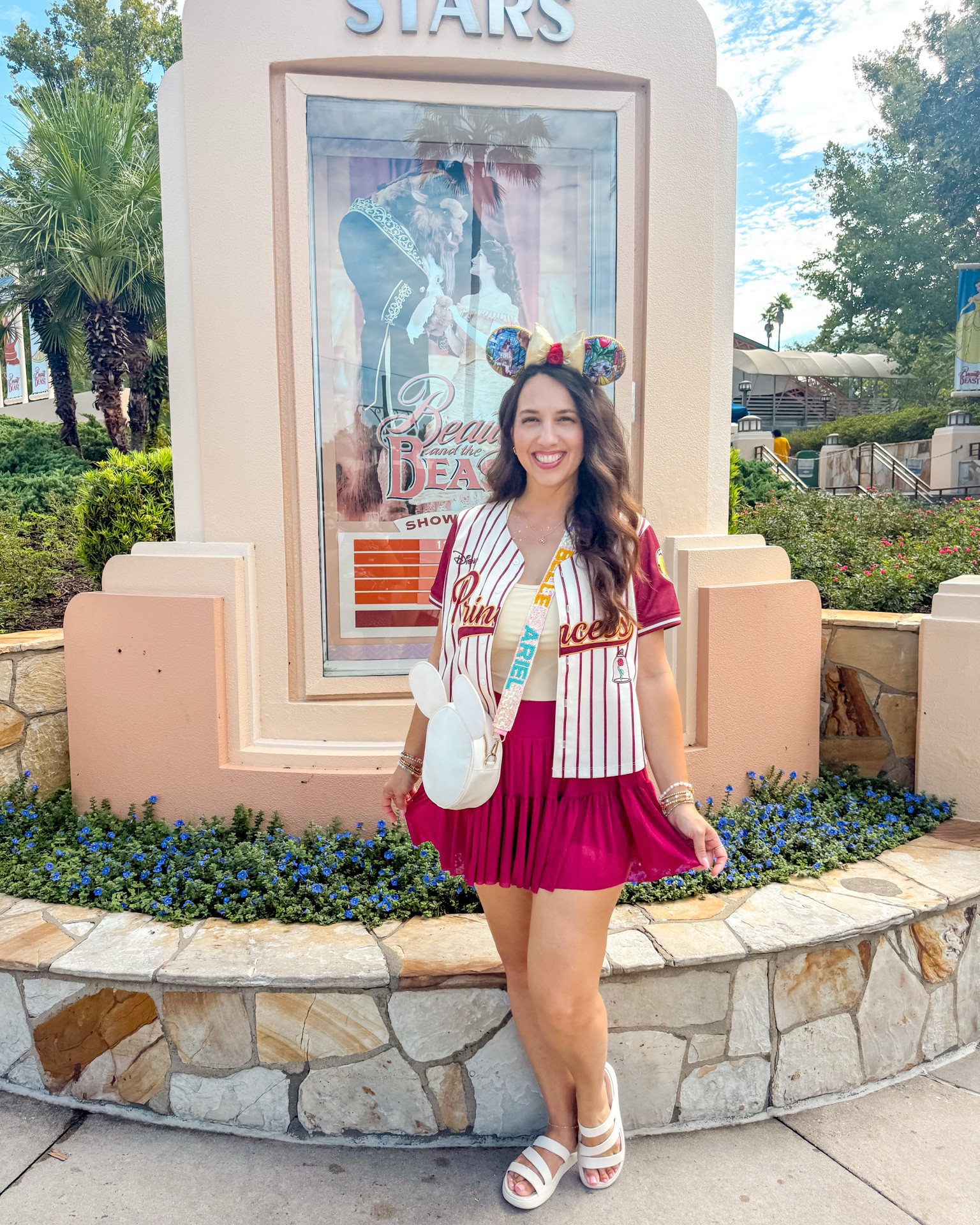 “There must be more than this provincial life…” 💛🌹✨
Princess #6 of Princess Week! 👑 A little Belle-inspired outfit for all my Beauty and the Beast girls. 📚🌹
✨ Skirt — Popflex
💛 Athletic Top — Pinspark
🏰 Belle Jersey — BoxLunch
👑 Ears — Etsy
👜 Bag + Princess Strap — Adored Luxe | code DEANN10
🩴 Sandals — Crocs
✨ Bracelets — BaubleBar + Little Words Project
💎 Necklace + Earrings — Kendra Scott
✨ Outfit details are linked in my LTK!

#LTKActive #LTKootd #LTKTravel