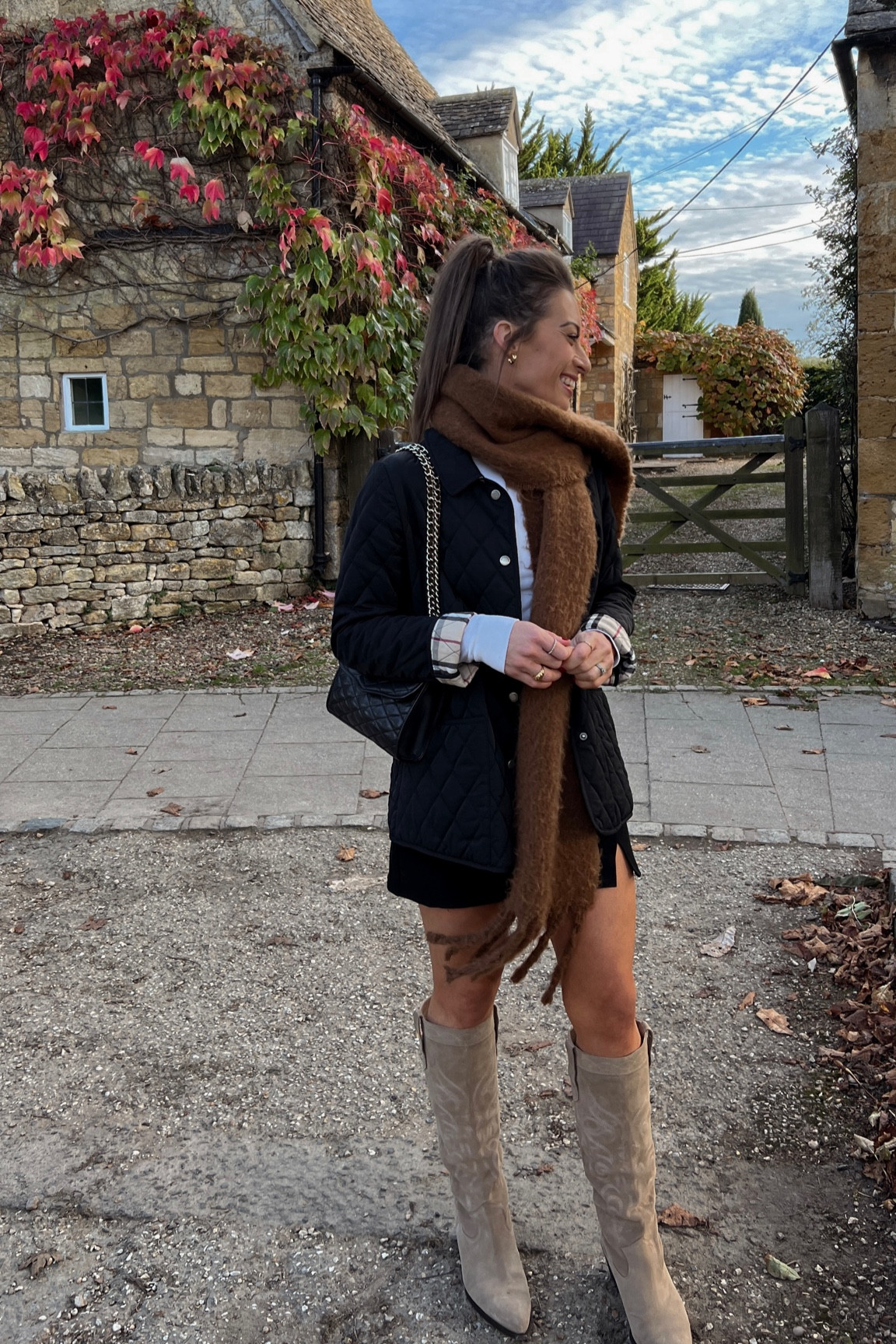 Fall outfit. Fall style. Cotswolds England. Black mini skirt. Suede western boots. Burberry quilted jacket. Fluffy brown scarf. Fall outfit ideas. Fall outfit inspo. Fall style inspo. What to wear. Fall trends. Burberry quilted jacket. Barbour quilted jacket. 

#LTKstyletip #LTKtravel #LTKeurope