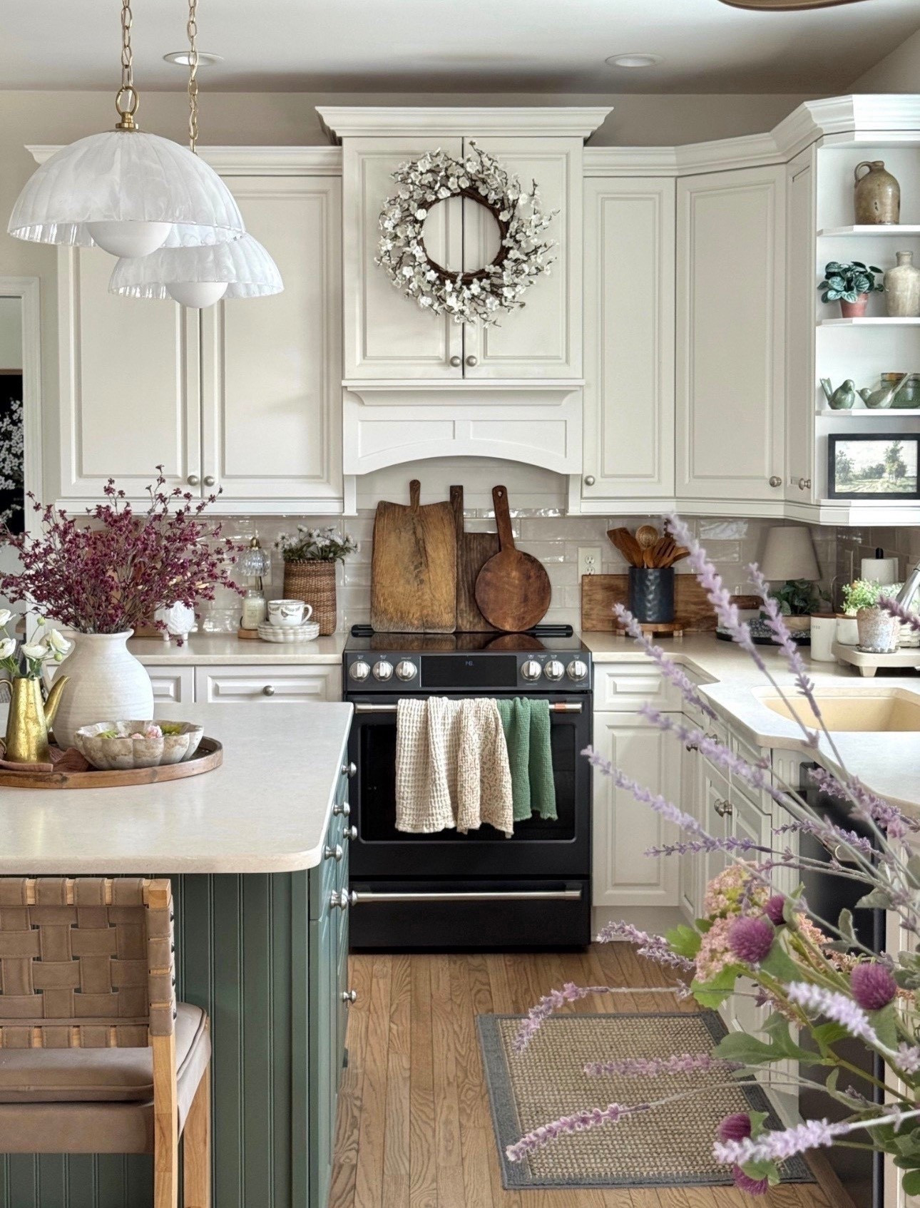 Kitchen decor 

swirled glass pendant lights with natural brass accents and chain, 24” plum blossom wreath, large round wooden tray, rattan wall basket set of two, distressed cutting boards set of three, scalloped white dessert plates, pretty pheasant patterned mug, waffle towels, matte black utensil holders set of two, wooden utensils, neutral counter stools  

#LTKHome #LTKSeasonal