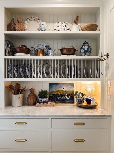 Kitchen open shelf decor - lamp, woven pineapples with lids, lazy Susan, ginger jar, scalloped woven tray, blue and white plates, planters 

#LTKsalealert #LTKstyletip #LTKhome