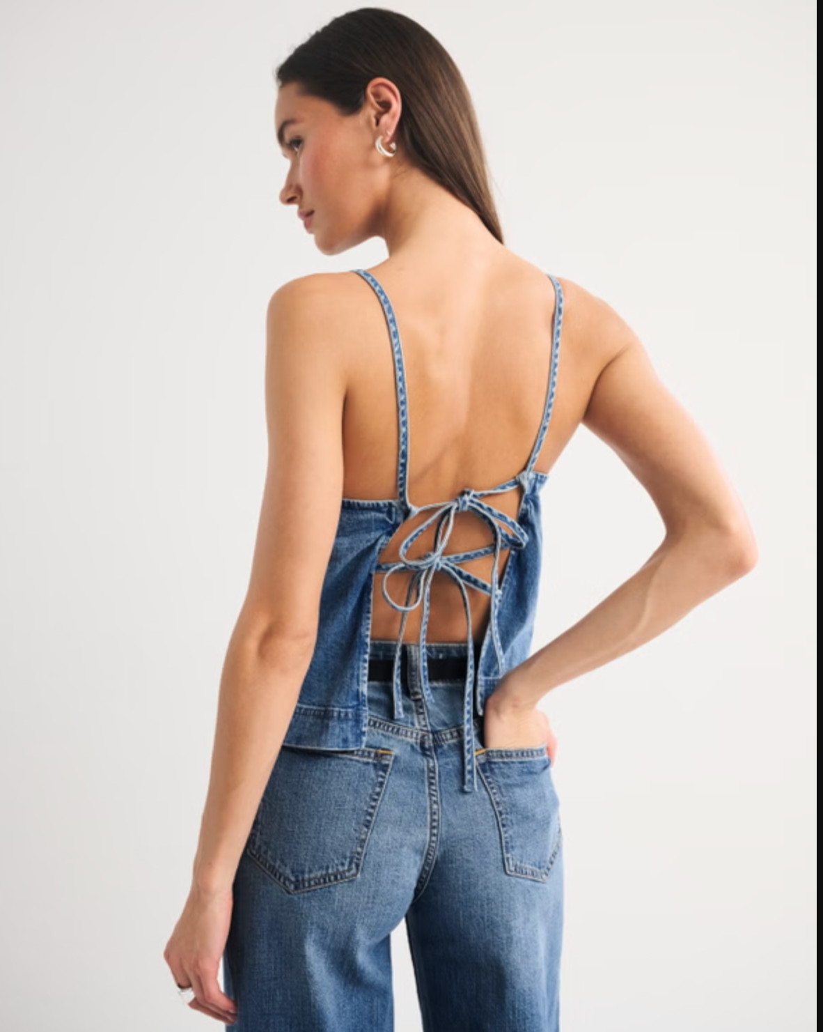 Summer staple 🤍 The Abercrombie Bra-Free Linen-Blend Denim Tie-Back Cami is part of their bra-free collection with built-in support (removable pads!) for an easy, no-fuss fit. I love the flattering apron neckline and adjustable tie-back detail, plus the lightweight linen-blend denim fabric is perfect for warm days. So cute styled with shorts, linen pants, or a matching set ✨ 

 #LTKFestival #LTKdayinmylife #LTKgrwm