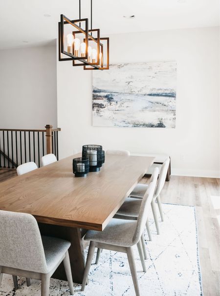 Modern, neutral and laid back dining room. 8 person wood dining table with minimal furniture and decor. Geometric black chandelier.

#LTKhome