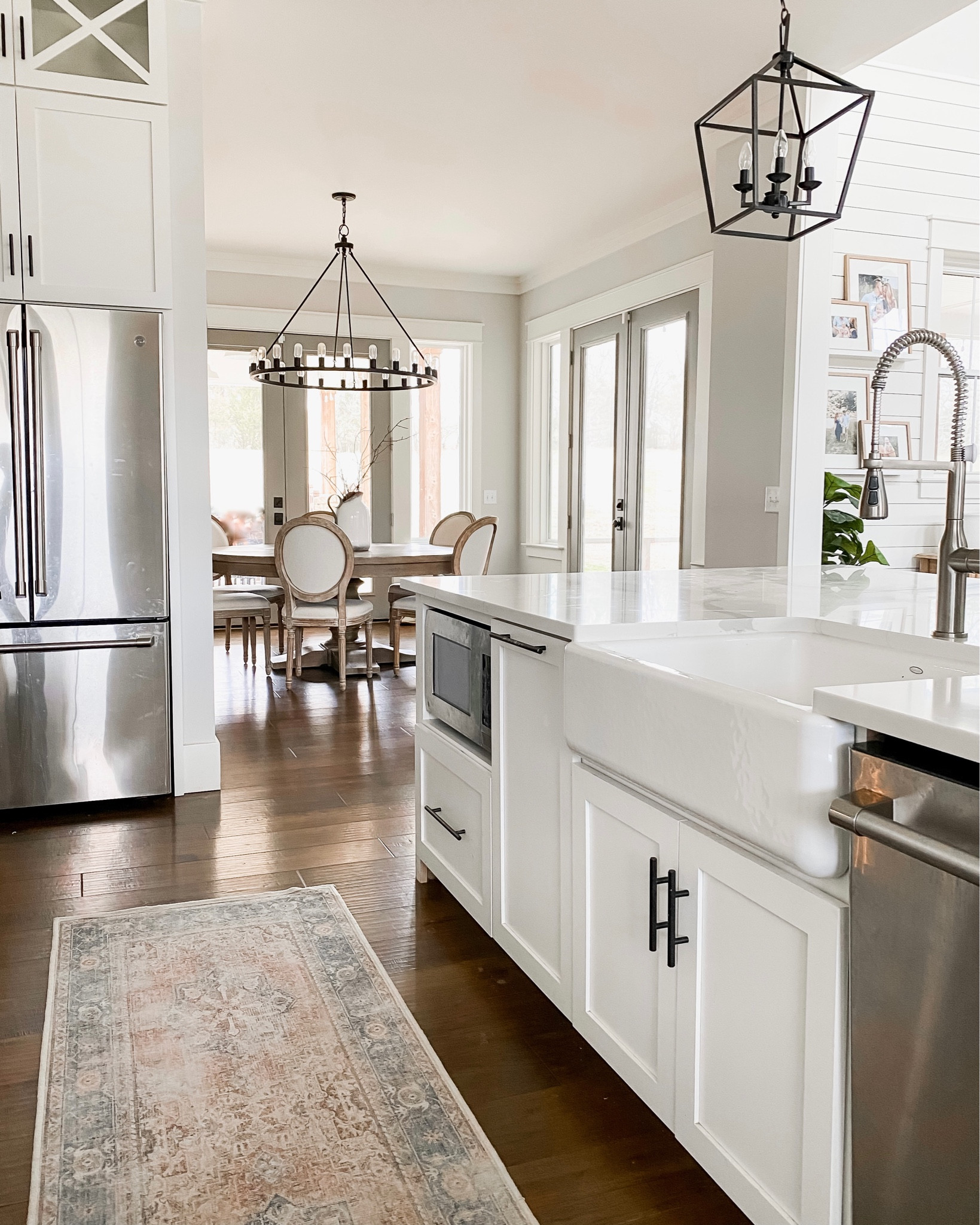 Kitchen and dining room styling home, decor, accents, and accessories, furniture round pedestal, dining table, round back dining chairs, wagon wheel, 24, light 48 inch chandelier, lantern island, pendant, light fixtures, apron, front sink, ruggable washable rugs, and runners faucets

#LTKsalealert #LTKhome #LTKFind