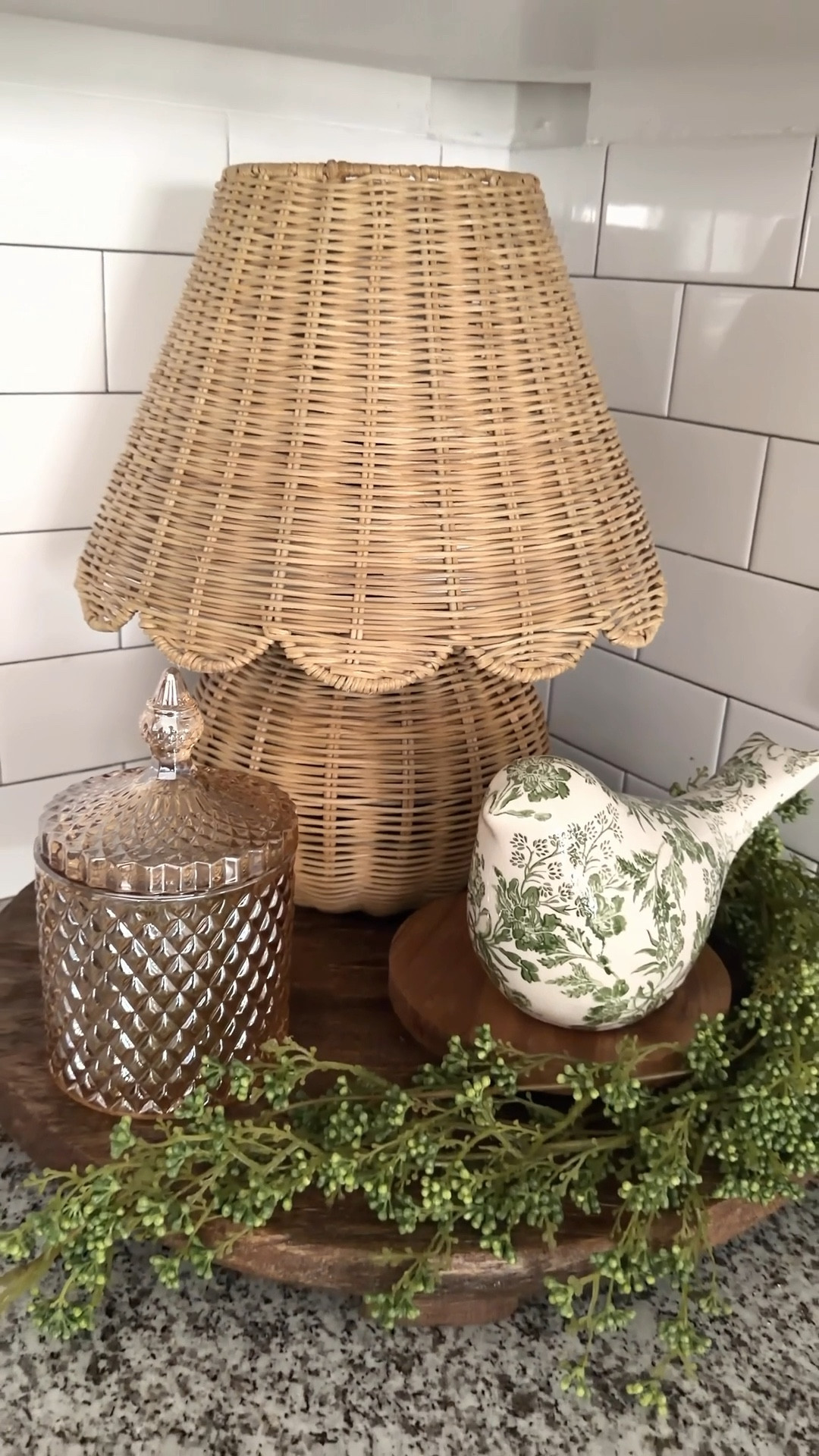 Corner styling can feel a little tricky, but it doesn’t have to be complicated. I almost always start with a round tray as my base… it just makes everything feel grounded and pulled together.

I’m loving this lamp, so I added a rechargeable bulb with a remote to bring in that soft, cozy lighting right in the kitchen. Then I layered in a crystal candy dish for treats, a pretty bird, and some greenery to freshen it up.

Simple, functional, and still so pretty  