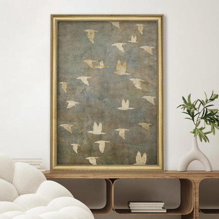 Gold framed wall art showing golden birds in flight on dark background