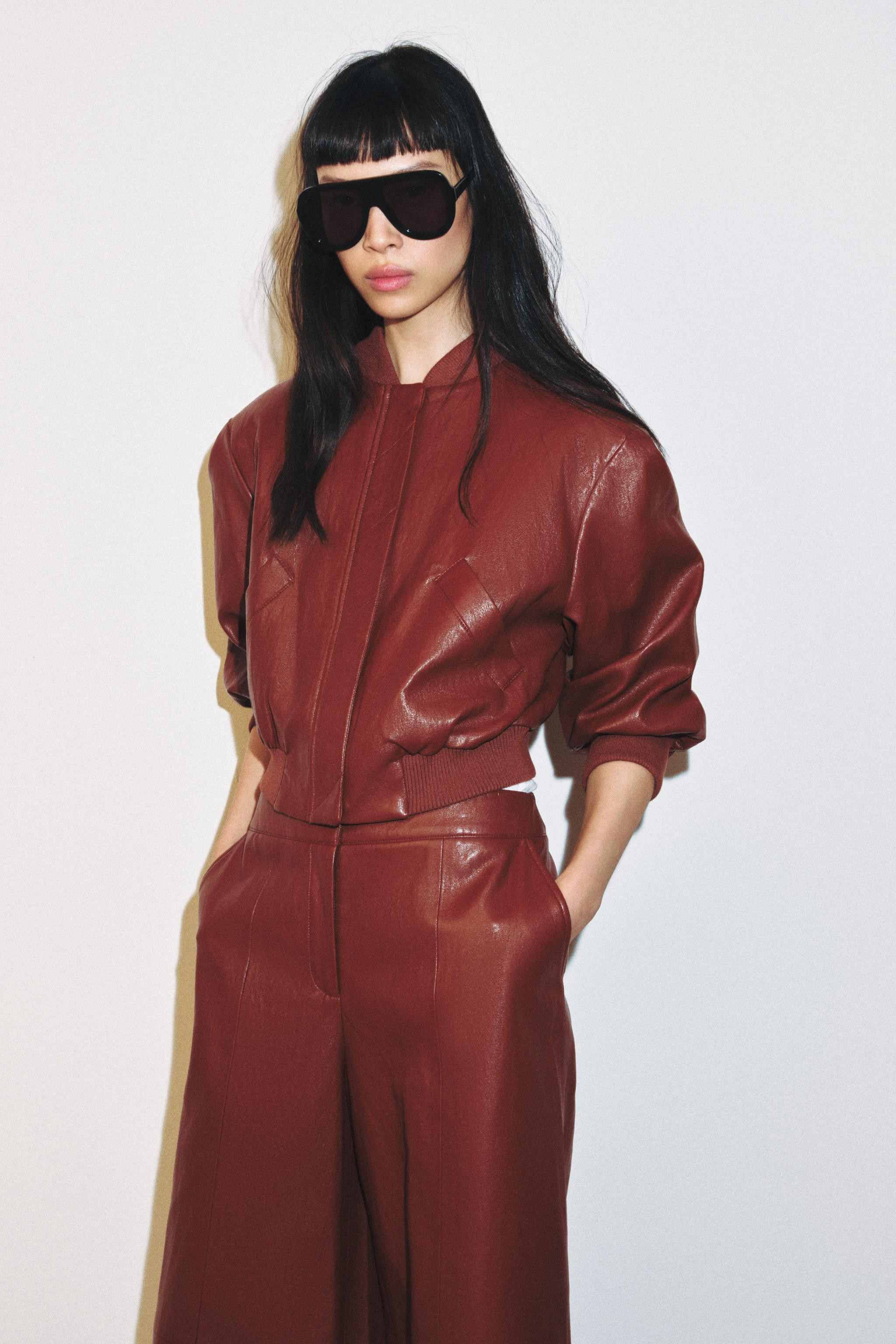 Short bomber jacket with a round neck and elbow-length sleeves with shoulder pads. Featuring fron... | Zara UK