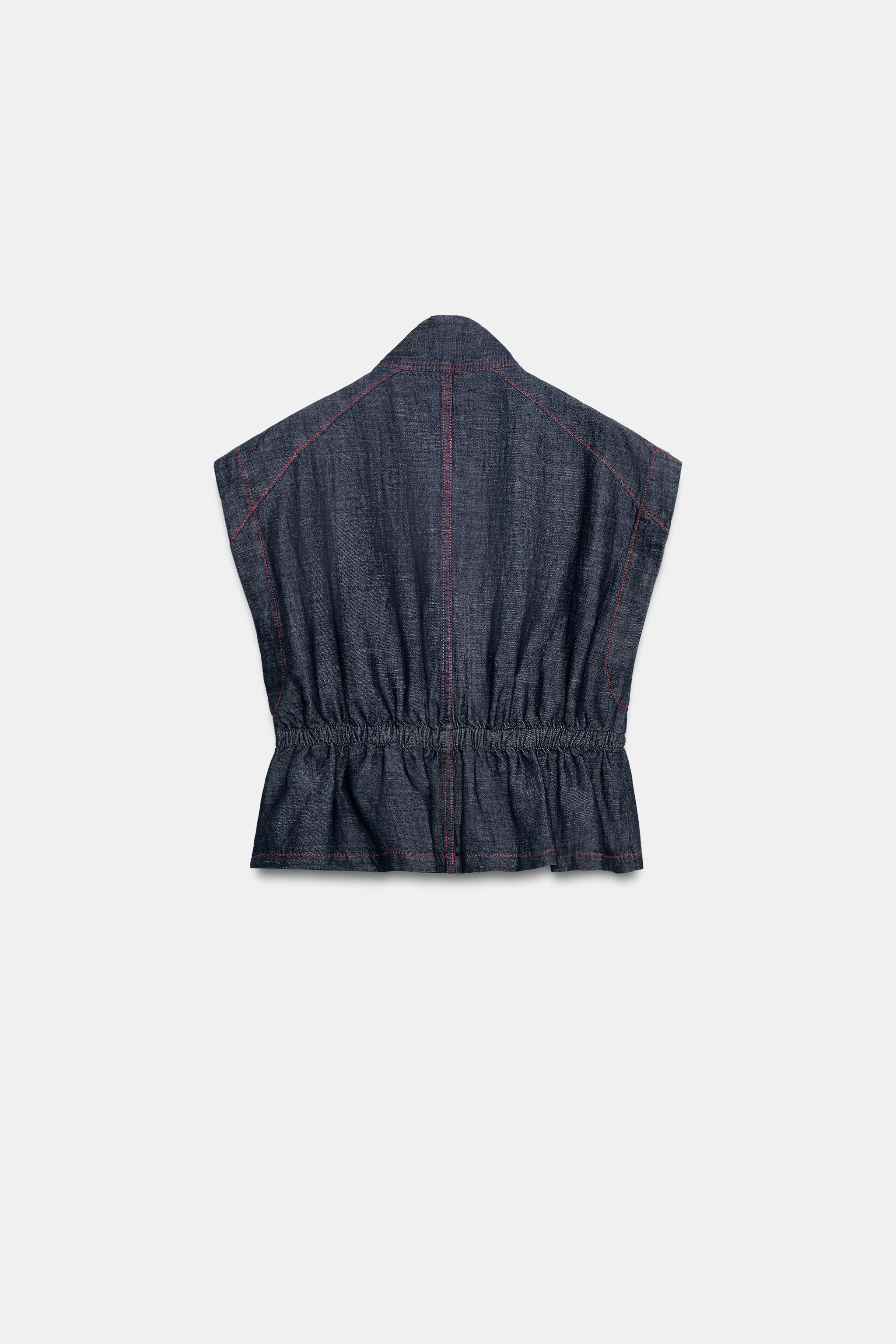 Vest made of linen. High collar. Sleeveless. Contrasting topstitching detail. Elastic waist. Fron... | Zara US