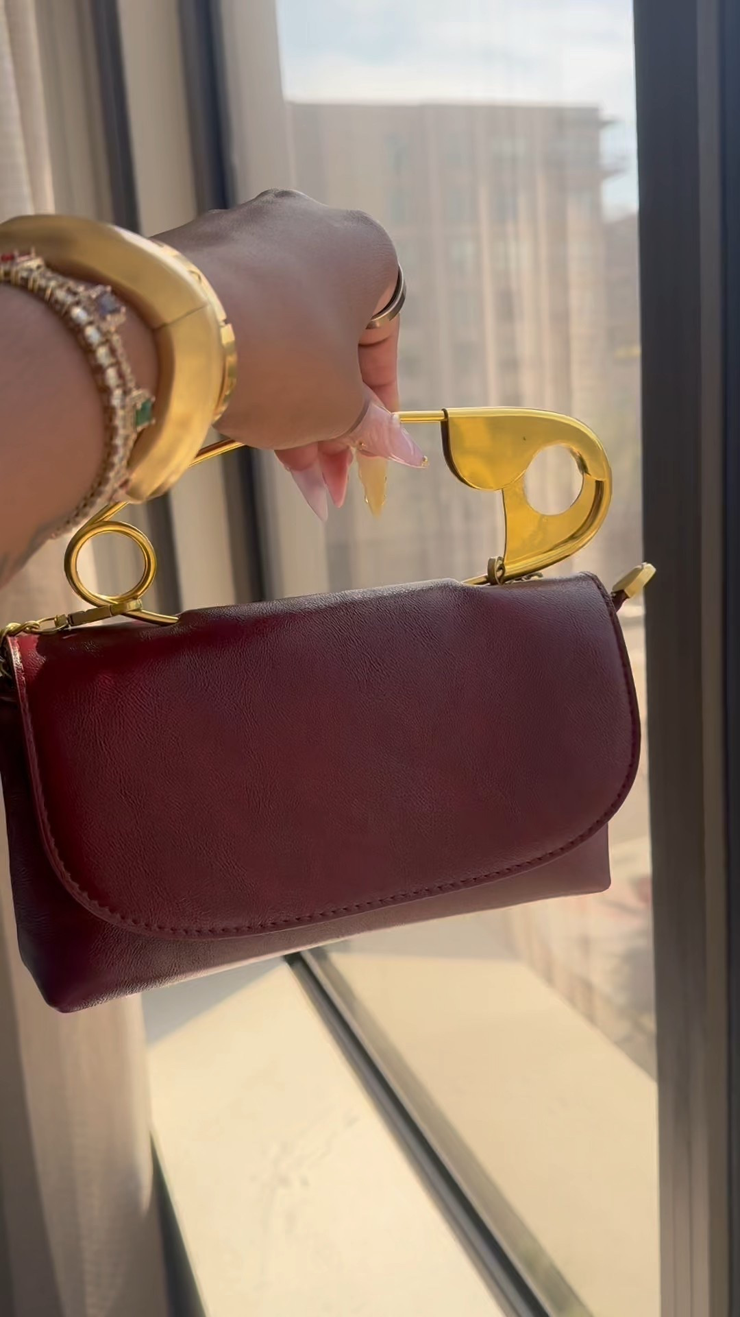 High fashion, leather safety pin purse with gold hardware 