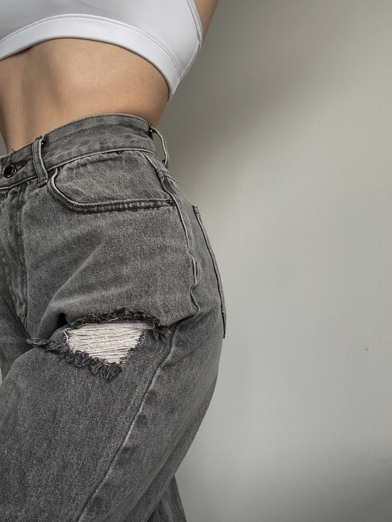 Baggy grey ripped jeans, white sports bra crop top, staple pieces 

#LTKsalealert #LTKunder100
