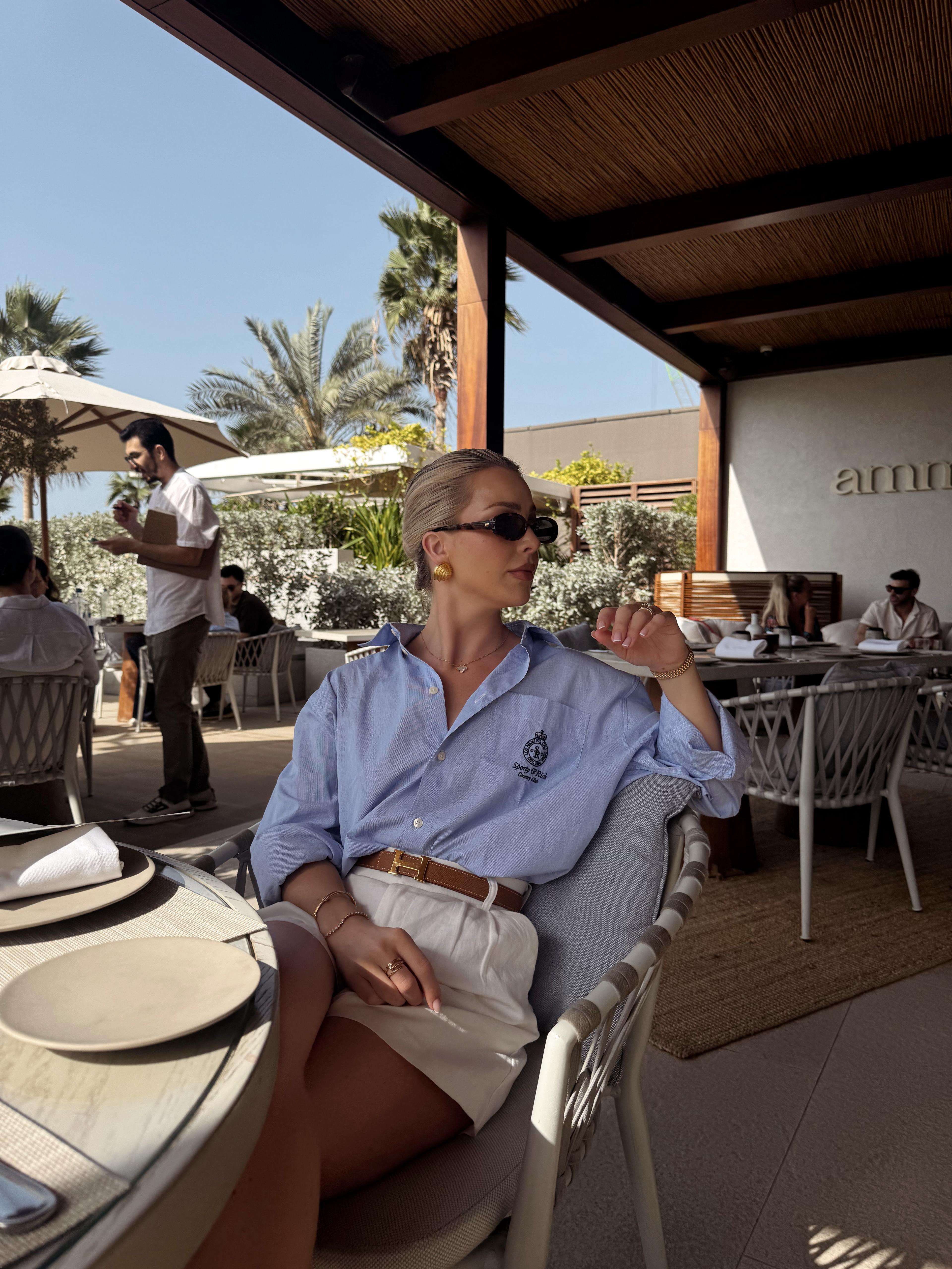 Winter sun, holiday outfit, blue shirt & shorts outfit, white linen Abercrombie shorts, blue sporty & rich shirt, neutral accessories, chunky earrings, le spec sunnies, Loewe bag, tan sandals, casual holiday outfit, Dubai outfit ideas  

 #LTKuk #LTKluxury #LTKstyletip